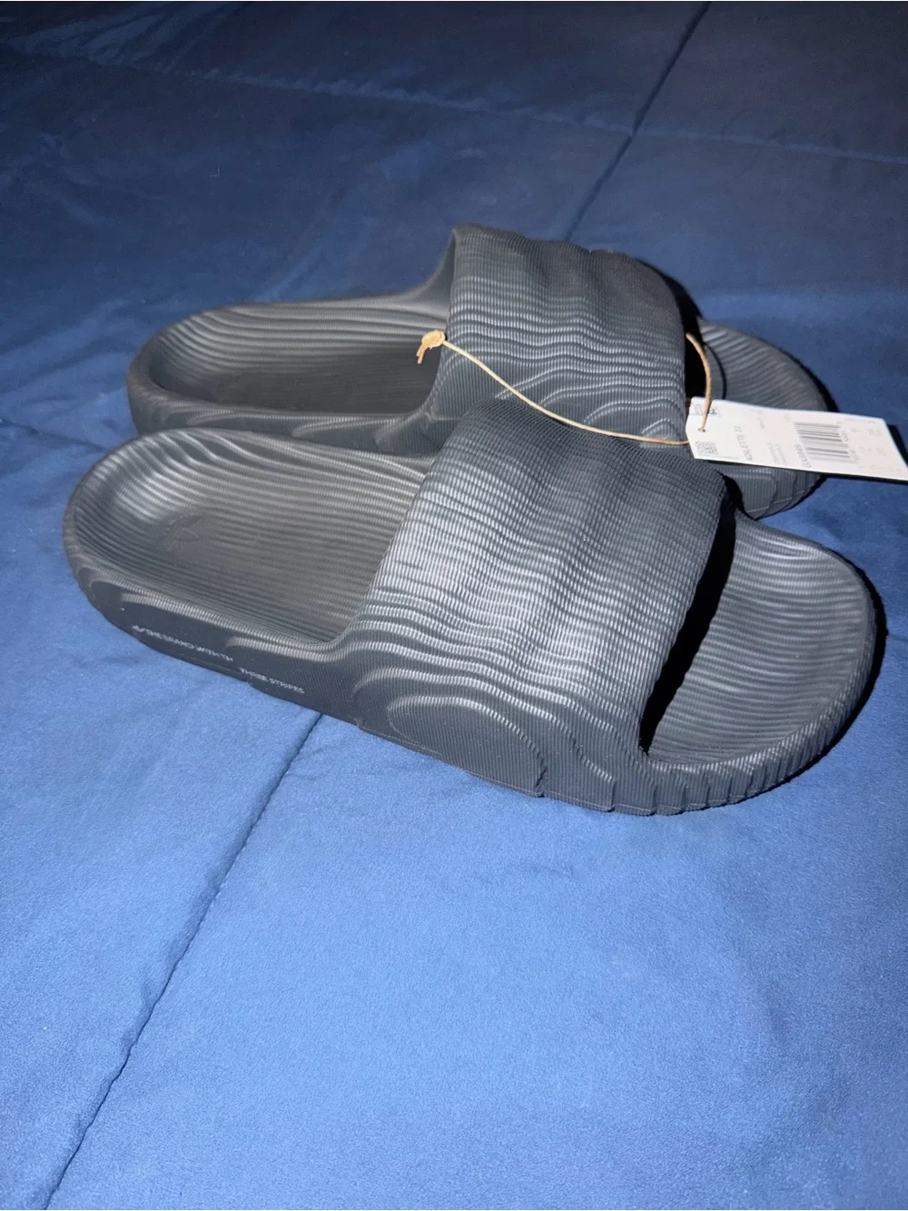 Adidas Adilette 22 Carbon Slides with a distinct 3D topographic texture